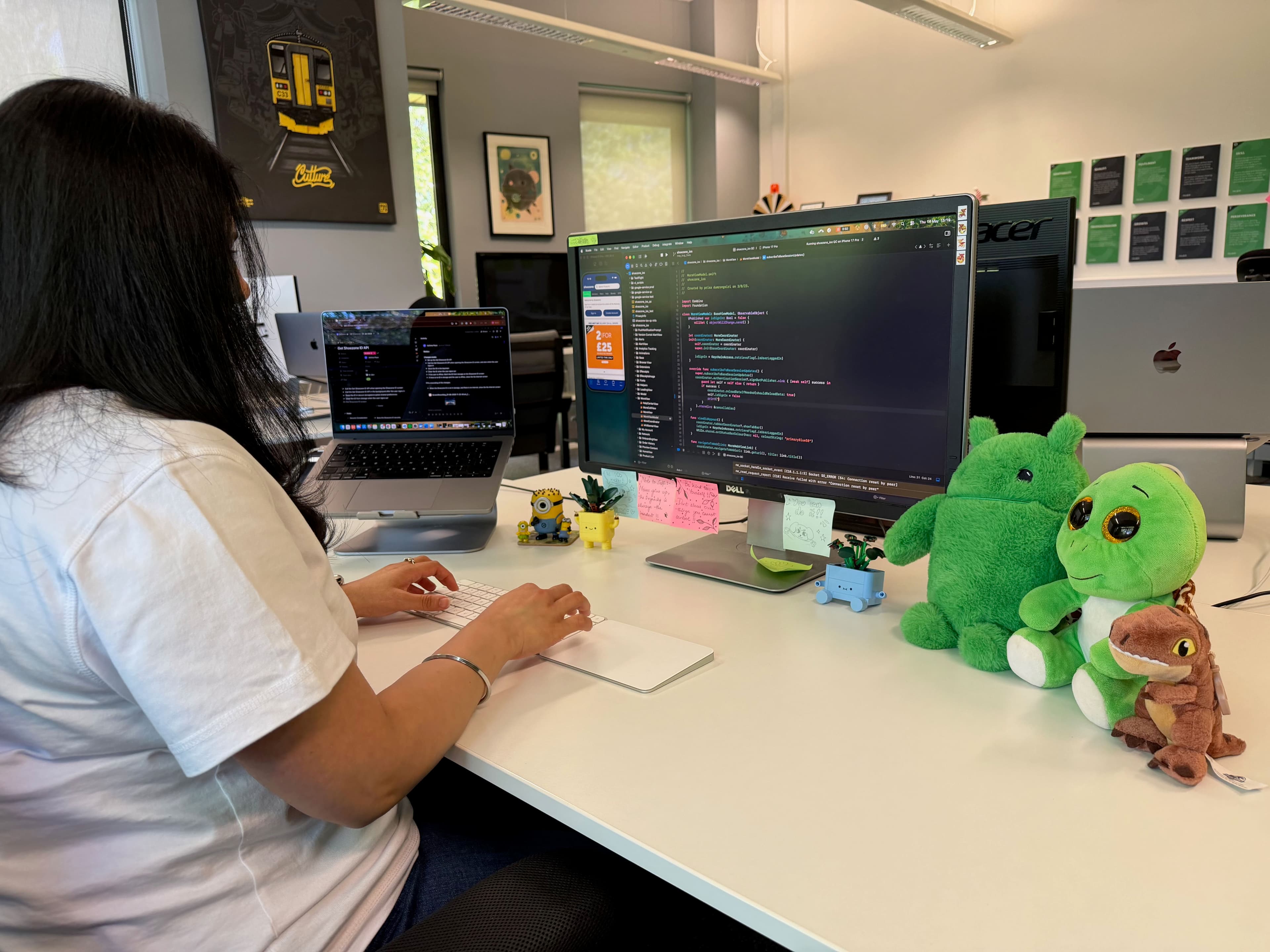 Ashima developing an iOS app on a laptop in the office